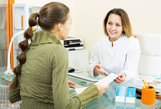 istock Client consulting smiling doctor in aesthetic center 869637230