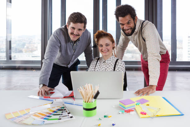 istock Business people in modern office posing for camera. 869637452