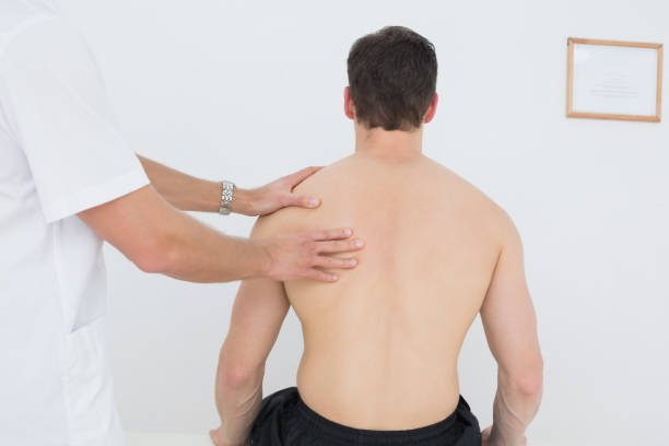 istock Shirtless man being massaged by a physiotherapist 869638674