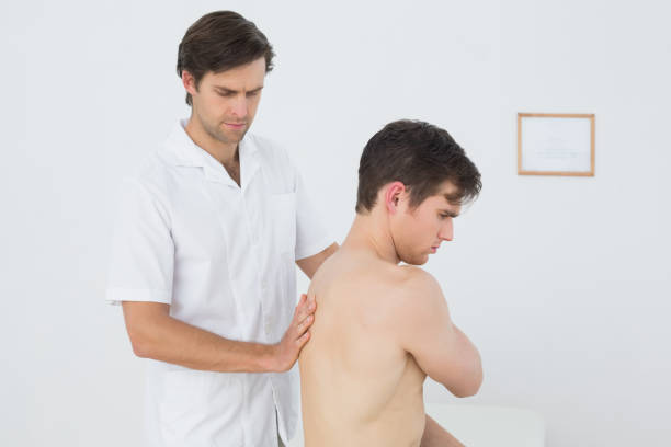 istock Shirtless man being massaged by a physiotherapist 869638740