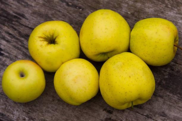 istock Ripe green apples on rustic wooden table 869642066