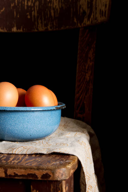 istock Eggs in a plate. Chicken farm. Dark background. 869645282
