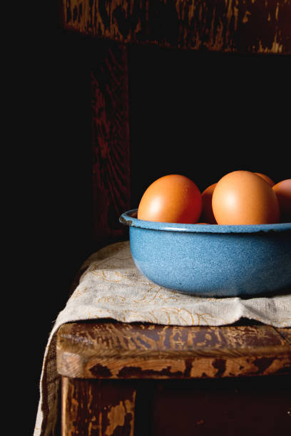 istock Eggs in a plate. Chicken farm. Dark background. 869645548