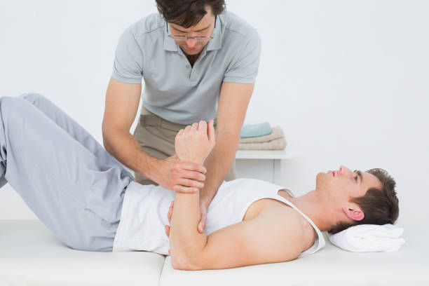 istock Male doctor examining a patients hand 869645590