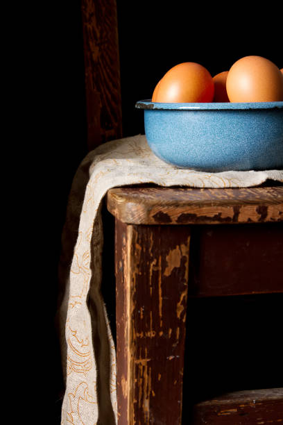 istock Eggs in a plate. Chicken farm. Dark background. 869645648