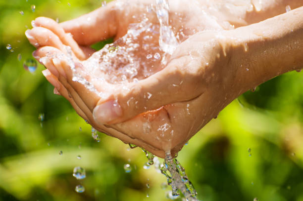 istock Woman washing hand outdoors. Hands with water splash, selective focus 869646798