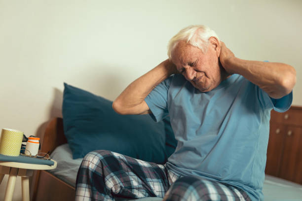 istock Senior Man Waking Up And Stretching In Bedroom 869650672
