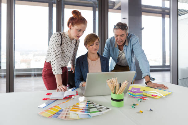 istock Business people in modern office working on laptop. 869651264