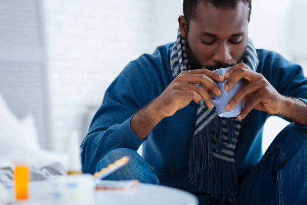 istock Unemotional quiet man drinking from his cup 869665198