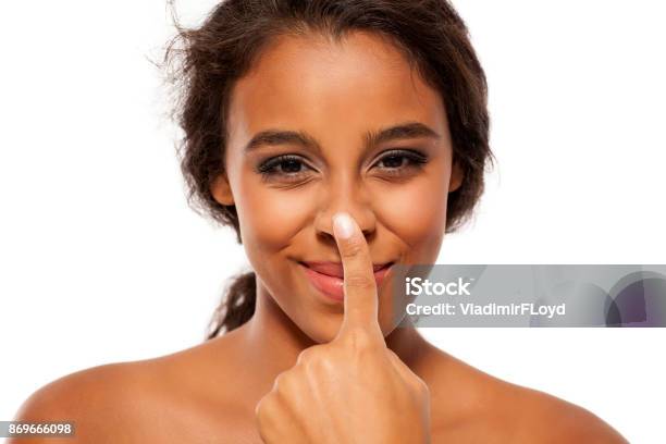 Young Dark Skinned Woman Touching Her Nose Stock Photo - Download Image Now - Nose, Touching, Women