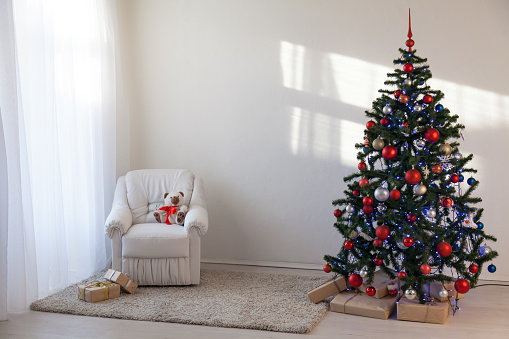 Christmas tree in a white room for Christmas with gifts 2