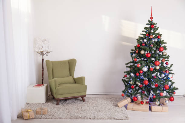 istock Christmas tree in a white room on new year's Eve 869667074