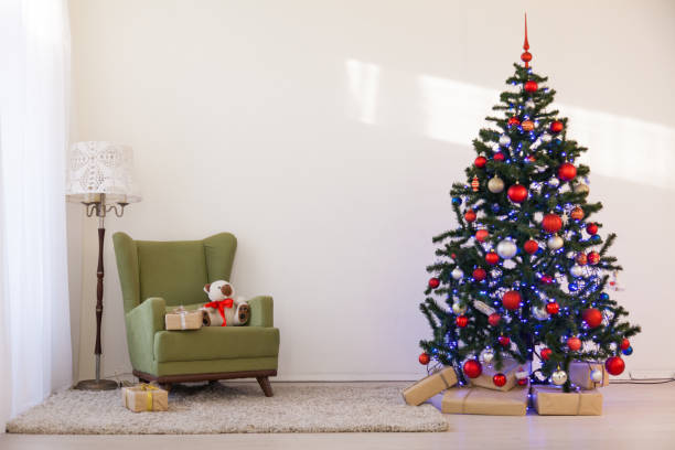 istock Christmas tree in a white room on new year's Eve 869667326