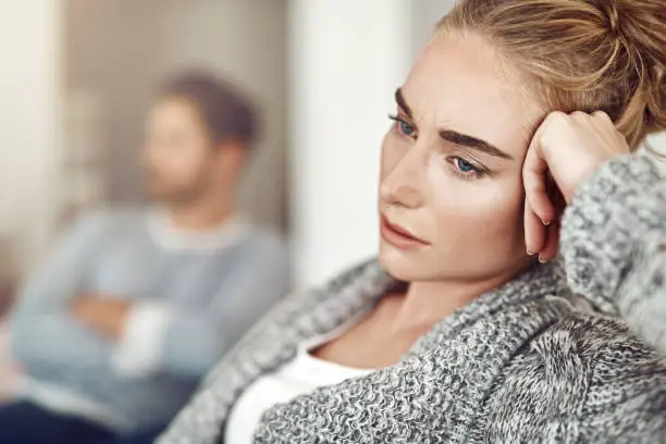 Cropped shot of an unhappy young couple after a fight at home