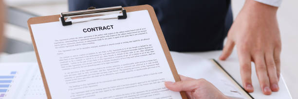 istock Male arm in shirt offer contract form on clipboard 869678516