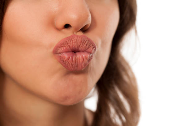 istock young woman showing her beautiful pursed lips 869683988