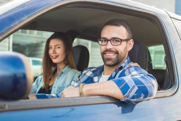 istock Couple driving in car 869686222