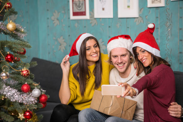 istock Friends celebrating Christmas: Smartphone selfie 869690826