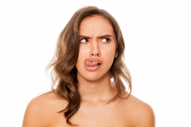 istock Young woman check her lips with her tongue 869691102