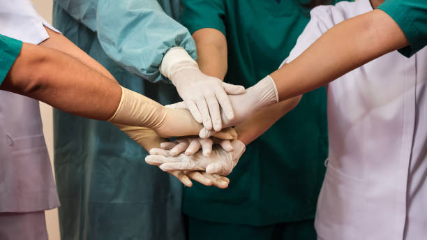 doctors and nurses coordinate hands. concept teamwork - team human hand cheerful close up imagens e fotografias de stock