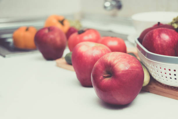 istock Red apples are placed on the table in the kitchen. 869694394