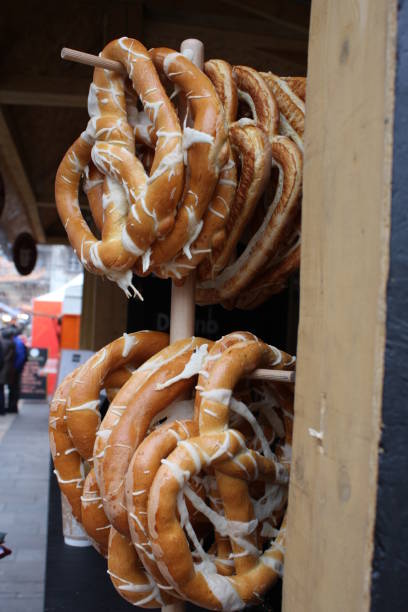 istock Pretzels on wooden board on rustic background. 869695452