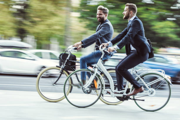 istock Two Young Businessmen Commuting With Bikes 869695726