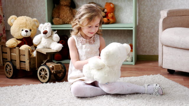 girl playing with a toy bear 4k