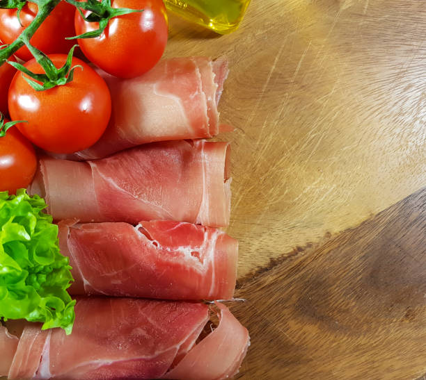 istock jamon wooden board cherry tomato, oil 869698592