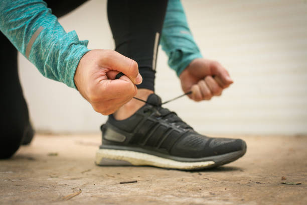 istock Man tying shoes before running. 869702222