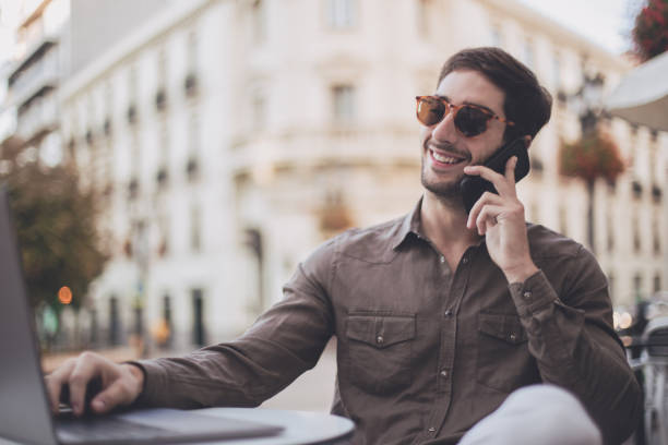 istock Smiling businessman talking on the phone 869702560