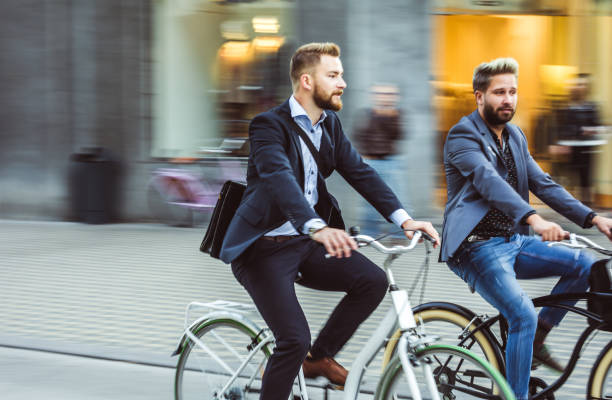 istock Two Young Businessmen Commuting With Bikes 869702756