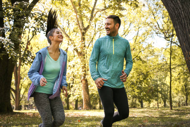istock Smiling couple running together trough nature. 869705778