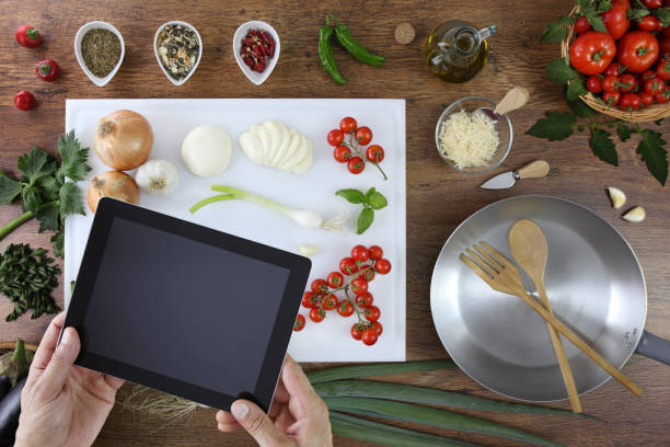istock food top view, hands with digital tablet on white cutting board in kitchen wooden worktop with tomatoes, vegetables and saucepan 869707084