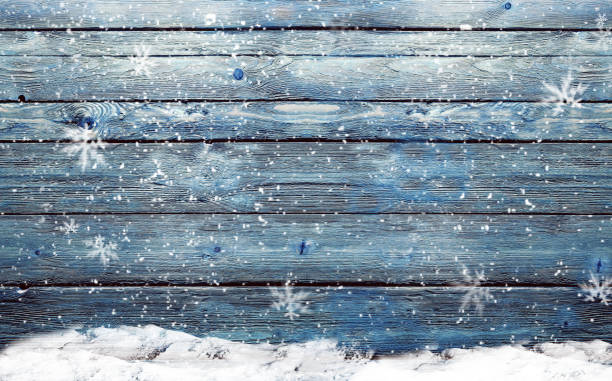 istock wooden background with snowflakes 869713220