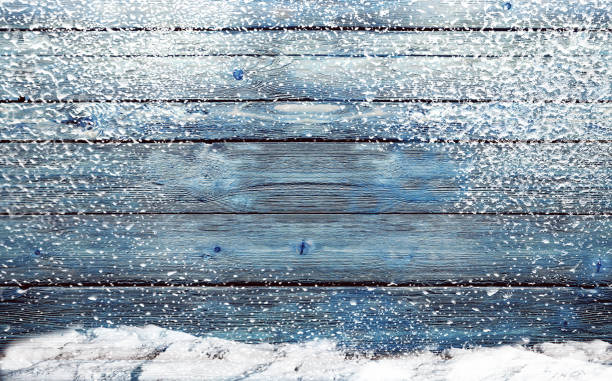 istock wooden background with snowflakes 869713226