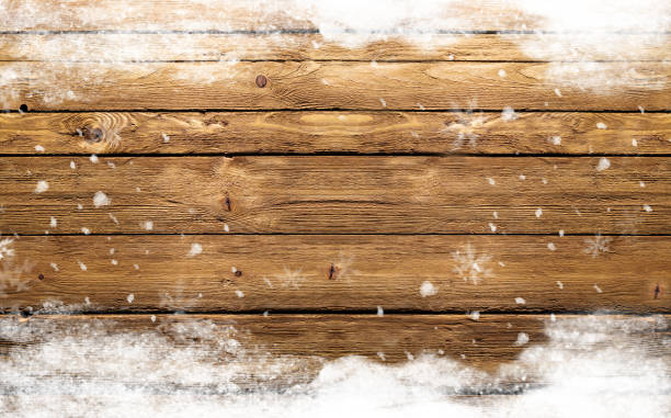 istock wooden background with snowflakes 869713236