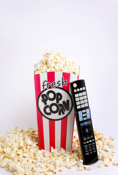 istock Remote control and box of fresh popcorn 869716696