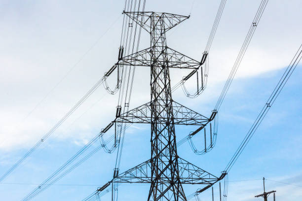 istock Electricity station. Close up high voltage power lines at sunset. 869718896