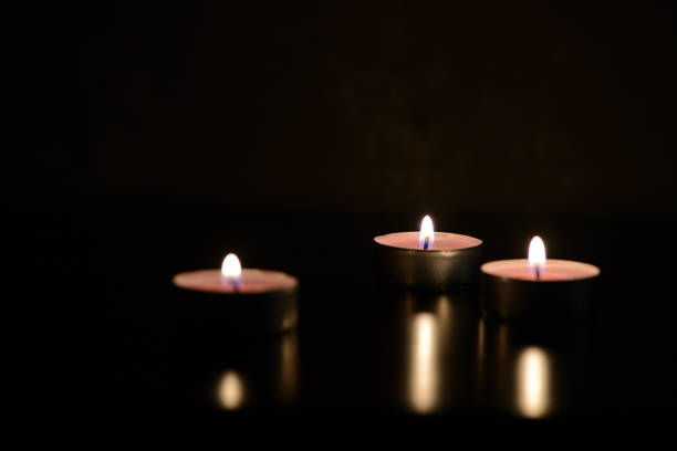 istock Three burning candles in the darkness 869722386