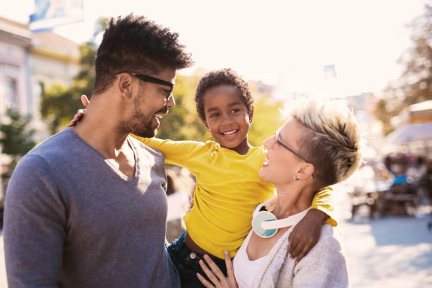 istock Happy young mixed race couple spending time with their daughter 869729204