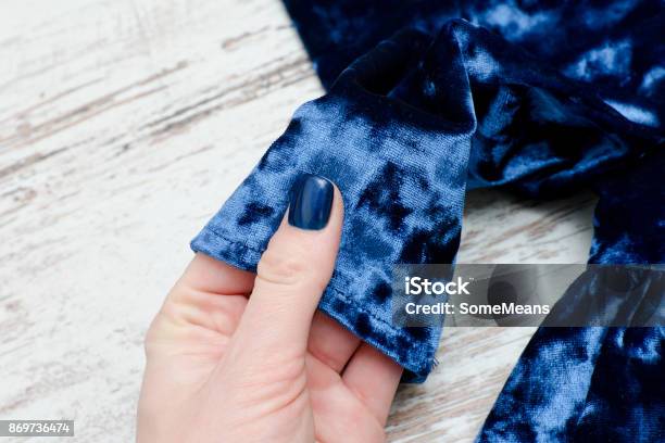 Sleeve Of Blue Velvet Dress In Female Hand Fashionable Concept Stock Photo - Download Image Now