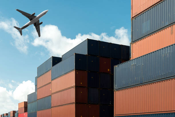 istock Stack of cargo containers with cargo airplane at import and export area at port. 869737346
