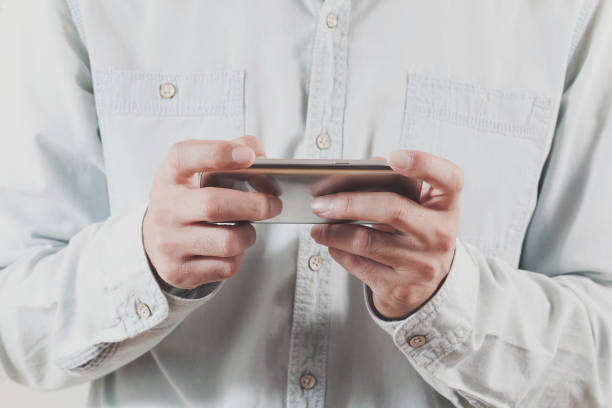 istock adult man is playing game with smartphone 869740888