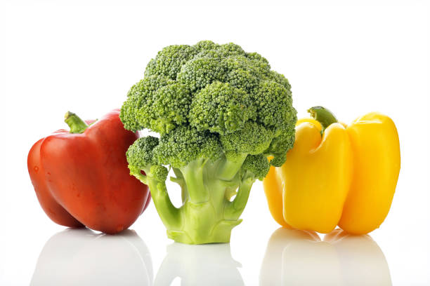 High resolution image of  fresh green broccoli with red and yellow bell pepper shot in studio on white background