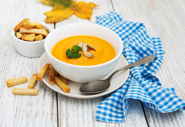 istock Pumpkin soup with fresh pumpkins 869743632