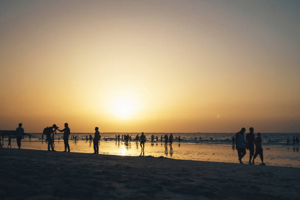 istock Sunset on a Busy Beach with Lots of People 869743802