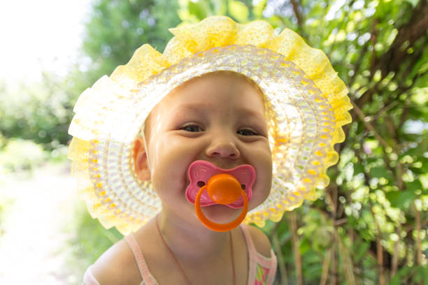 istock Cute baby with a pacifier in the sun 869749680