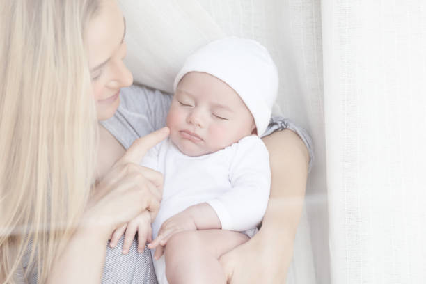istock Nice mother holding her adorable newborn baby 869753590