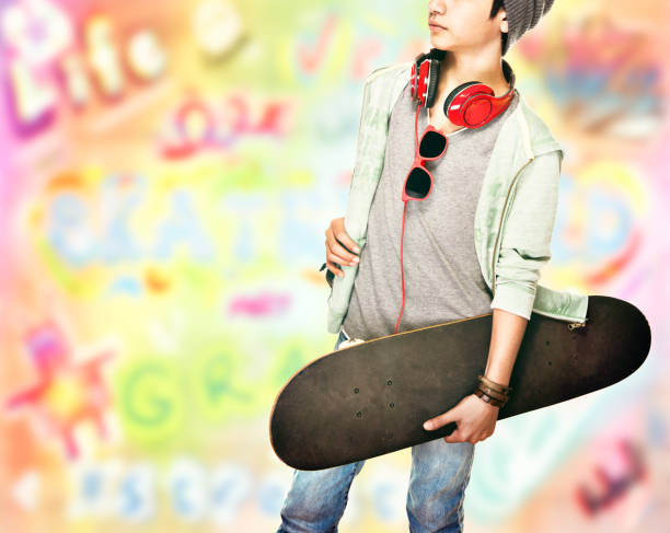 istock Stylish teen boy with skateboard 869756698